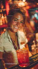 Cheerful Woman Bartender Serving Colorful Cocktail in Nightclub