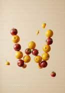 Floating Red Apples and Oranges on Beige Background