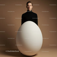 Calm man standing behind giant white egg on brown background