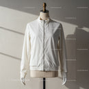 Minimalist white zip-up jacket on dress form