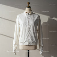 Minimalist white zip-up jacket on dress form