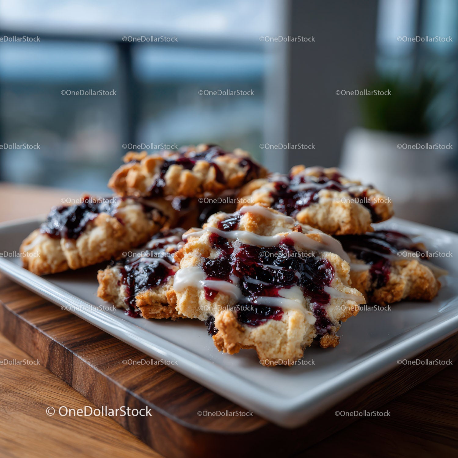 Delicious crumble cookies with berry jam and cream topping on a white plate