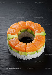 Fresh salmon and avocado sushi ring on black plate