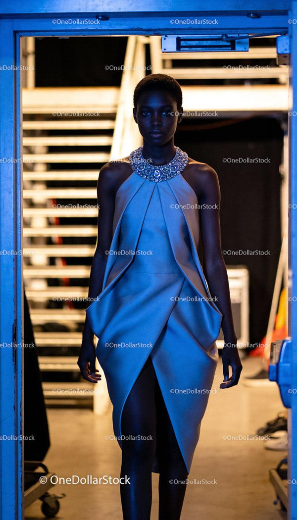 Elegant model in embellished necklace dress backstage