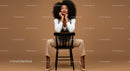 Fashionable Woman Sitting on a Black Chair in Studio Setting