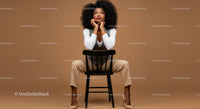 Fashionable Woman Sitting on a Black Chair in Studio Setting