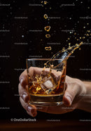Splashing Whiskey with Ice Cubes in Glass Held by Hand