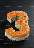 Fresh salmon avocado sushi roll on black slate