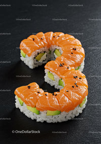 Fresh salmon avocado sushi roll on black slate