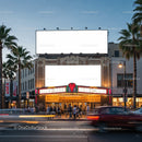 Historic theater facade with illuminated marquee at dusk