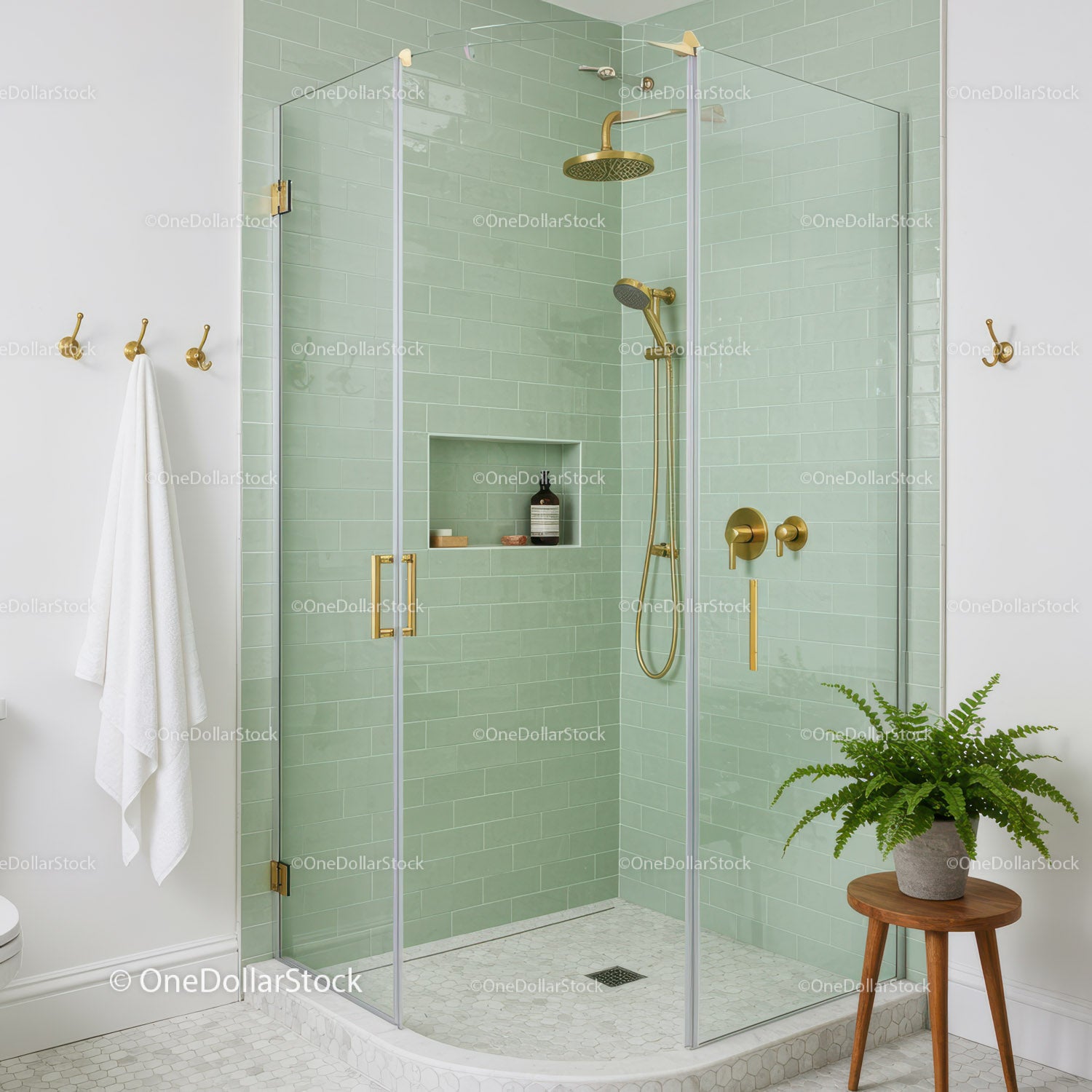 Modern shower enclosure with green tiles and gold fixtures