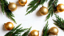 Golden Christmas ornaments with fresh green pine branches