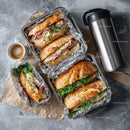Fresh Gourmet Sandwiches with Ham, Cheese and Greens on Baguette
