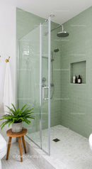 Minimalist bathroom with green tiled shower cabin