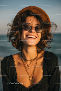 Joyful Woman Wearing Sunglasses on Beach in Warm Summer Weather