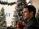 Thoughtful man admiring holiday decorations outdoors