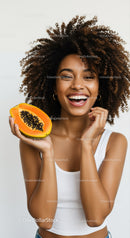 Smiling Woman Holding Papaya with Curly Hair and Bright Expression