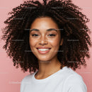 Young woman with curly hair smiling portrait on pink background