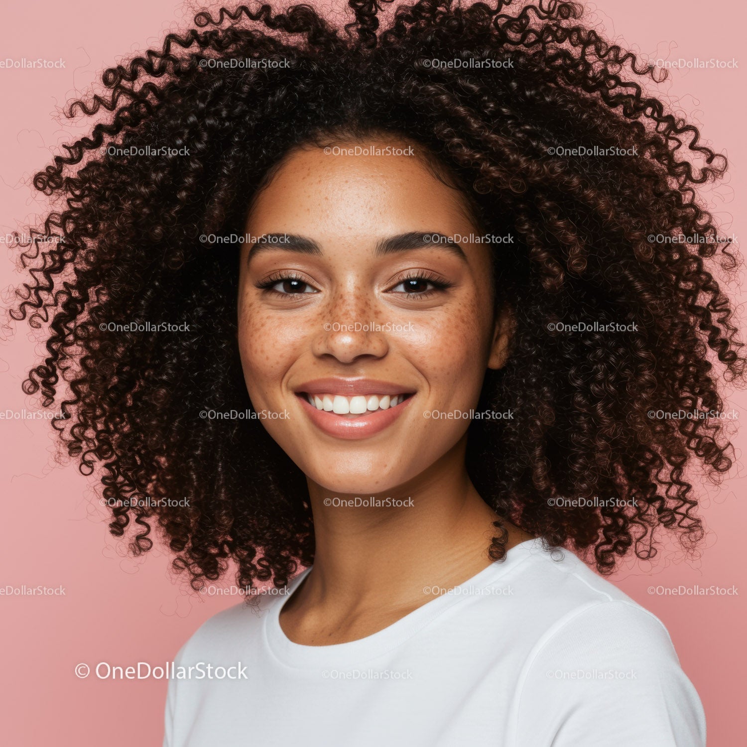 Young woman with curly hair smiling portrait on pink background