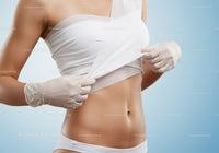 Woman Undergoing Medical Abdominal Examination with Healthcare Professional