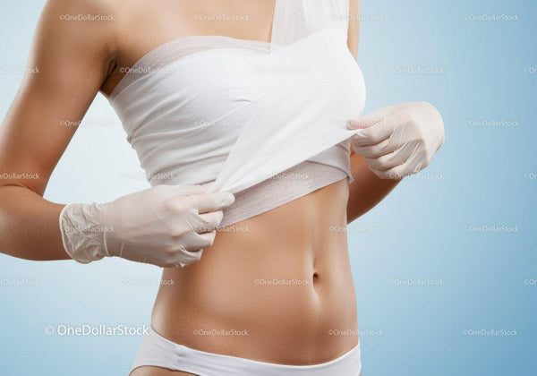 Woman Undergoing Medical Abdominal Examination with Healthcare Professional