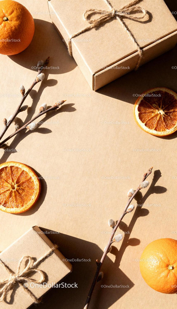 Natural gift boxes with dried oranges and blossoming twigs