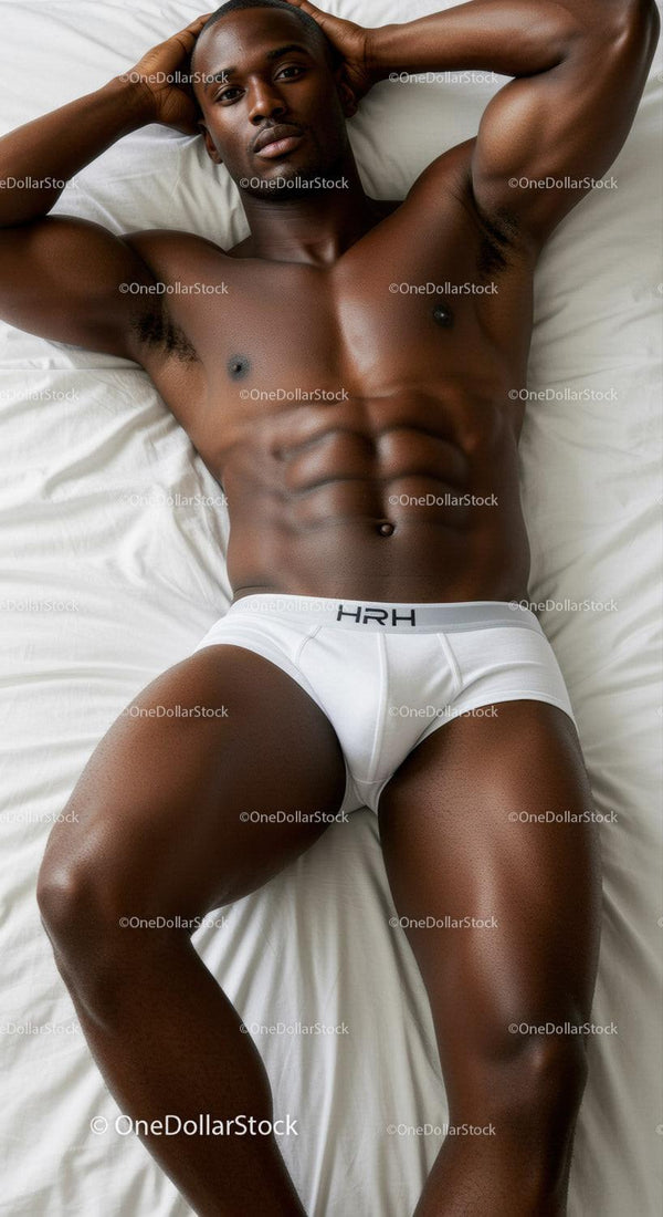 Fit man relaxing on bed in white underwear