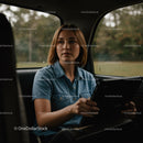 Young Woman Using Tablet in Car Back Seat on Rainy Autumn Day