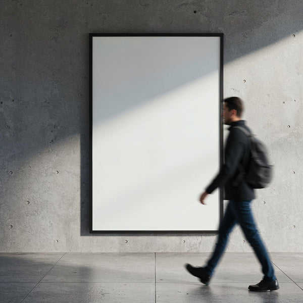 Man walking past blank poster on concrete wall JPG Mockup Image