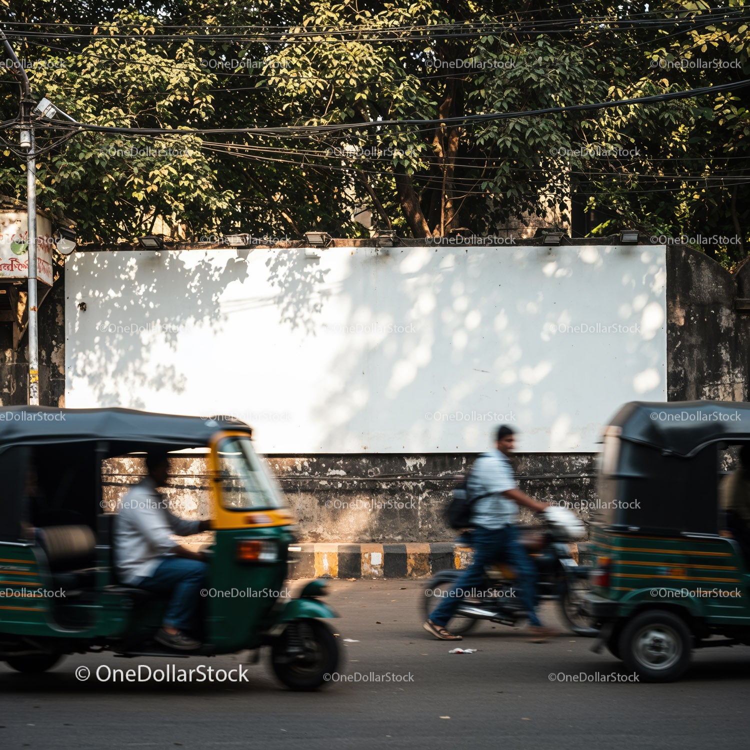 Busy urban street with passing auto rickshaws and pedestrians