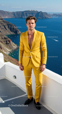 Confident man in vibrant yellow suit by the sea