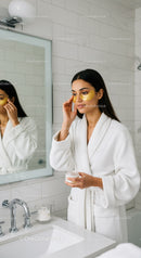 Woman Applying Facial Mask in Modern Spa Bathroom