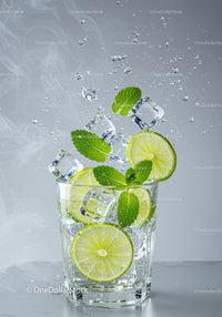 Refreshing lime and mint drink with ice splashing