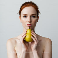 Elegant Female Portrait Holding Pear with Neutral Background