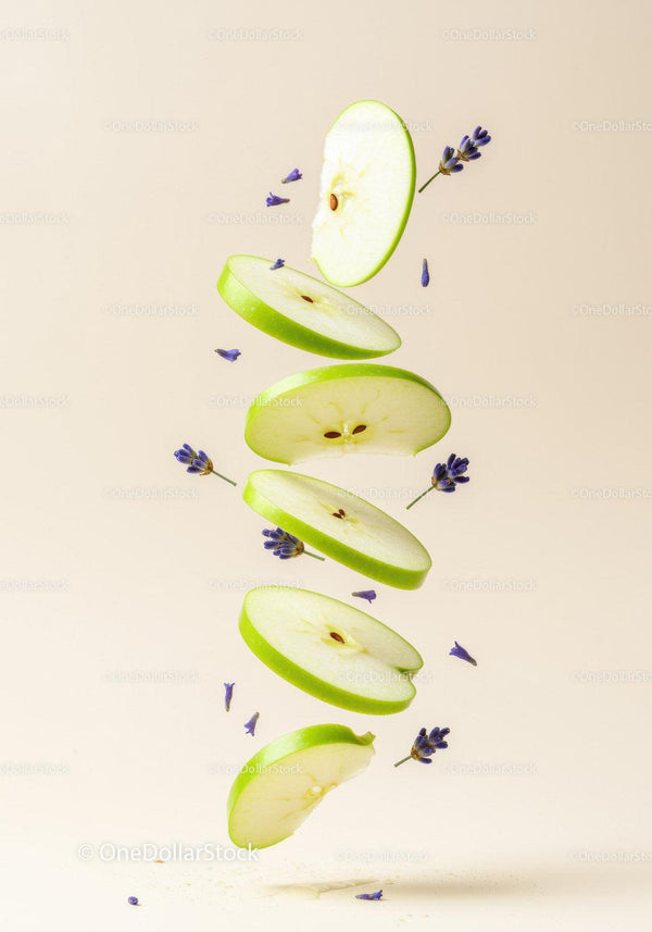 Floating slices of green apple with lavender flowers