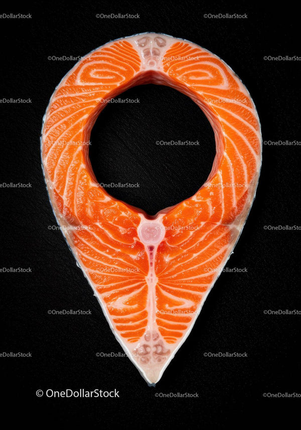 Raw salmon steak shaped like location pin on black background