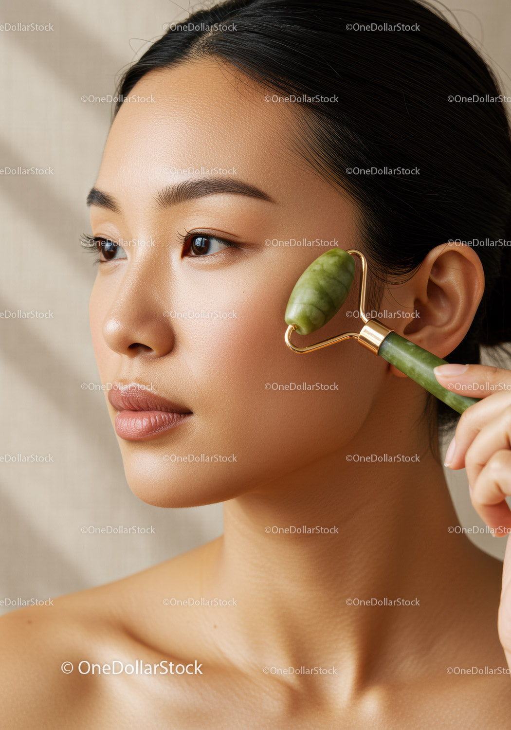 Close-up of Woman Using Jade Roller for Facial Skin Rejuvenation