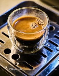 Espresso shot fresh brewed in clear glass cup