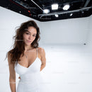 Beautiful Woman in White Dress in Studio Setting for Fashion Portrait