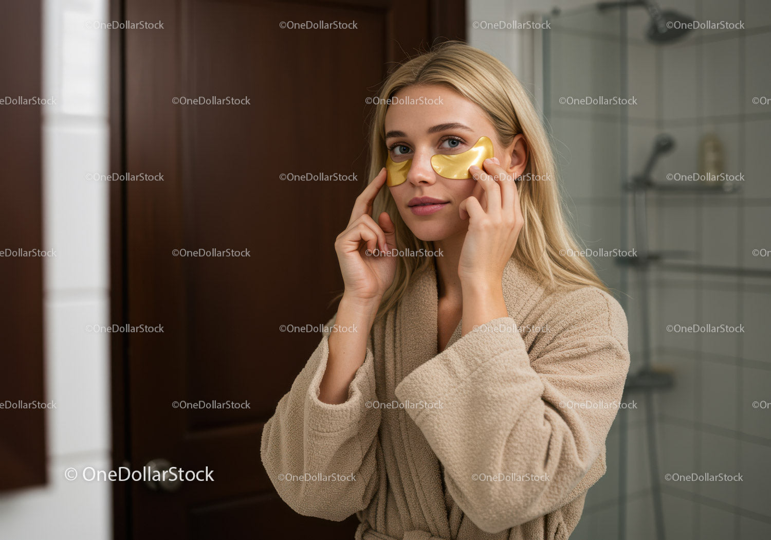 Young Woman Applying Gold Eye Patches in Spa Setting for Skin Rejuvenation