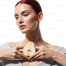Elegant Woman Holding Pear with Smooth Skin and Red Hair