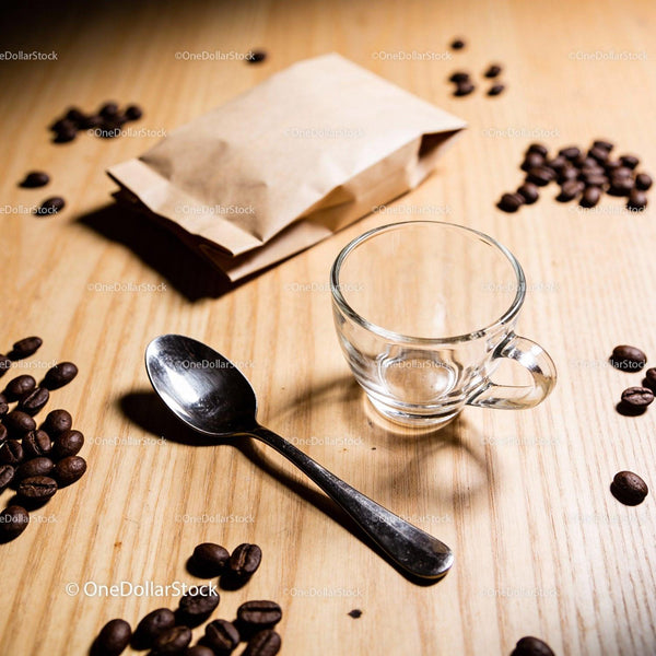 Empty Glass Coffee Cup with Spoon and Coffee Beans