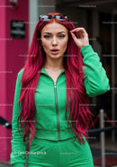 Vibrant Red Hair Woman in Green Tracksuit with Sunglasses in City