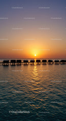 Beautiful Sunset Over Tropical Ocean with Overwater Bungalows