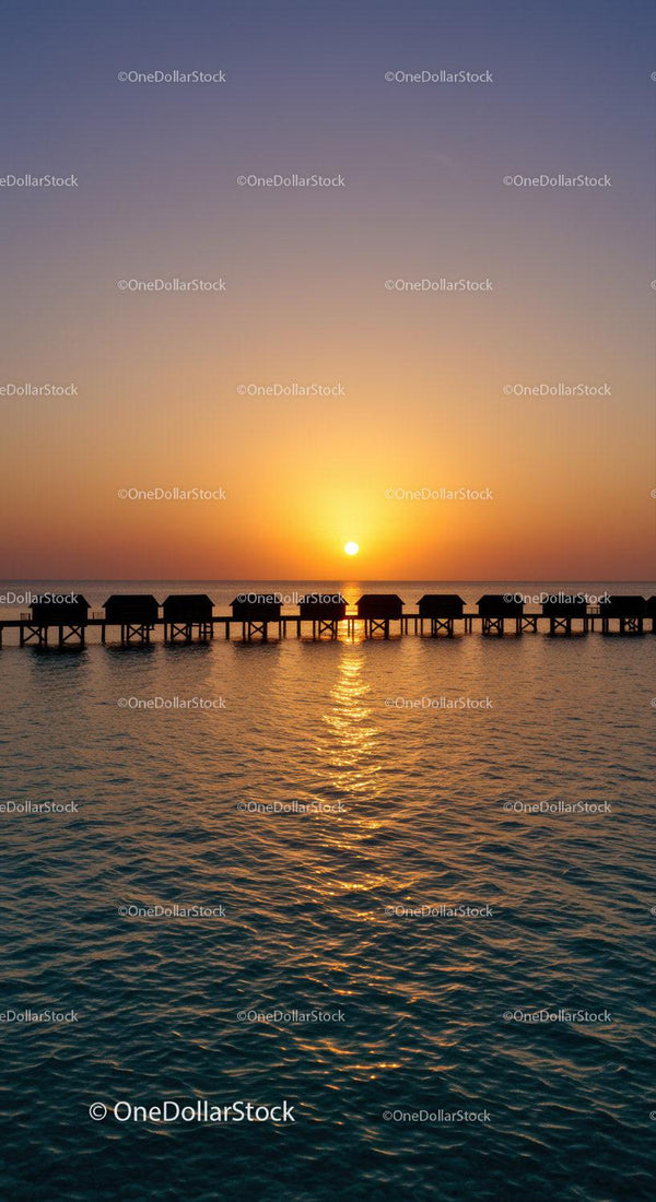 Beautiful Sunset Over Tropical Ocean with Overwater Bungalows