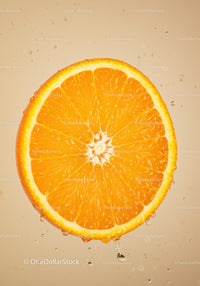 Fresh orange slice dripping with juice on beige background