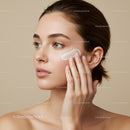 Young Woman Applying Moisturizer on Cheek in Skincare Routine