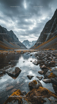 Rocky Mountain Valley with Reflective Water and Overcast Sky