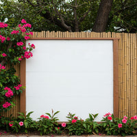 Blank white wooden board surrounded by blooming pink flowers