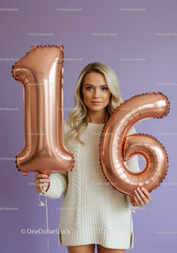 Young woman celebrating sixteenth birthday with balloons